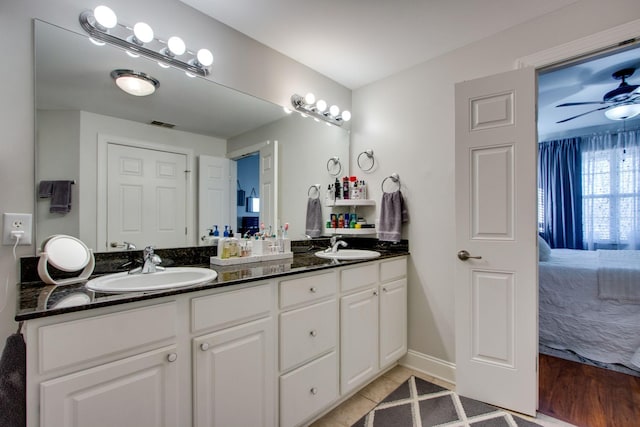 ensuite bathroom featuring a sink, double vanity, ceiling fan, and ensuite bath