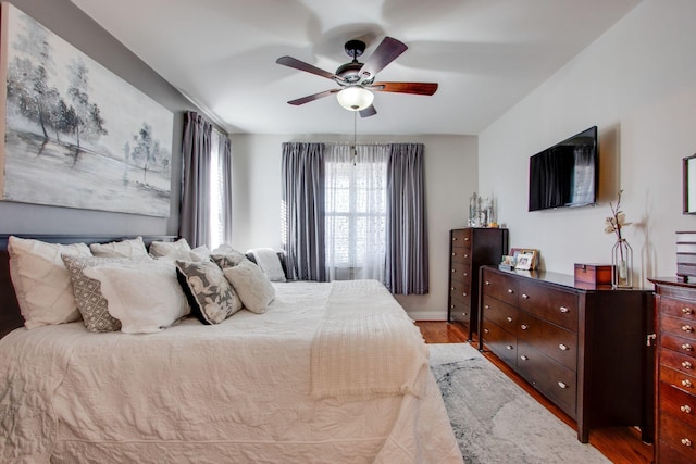 bedroom with a ceiling fan and light wood-type flooring