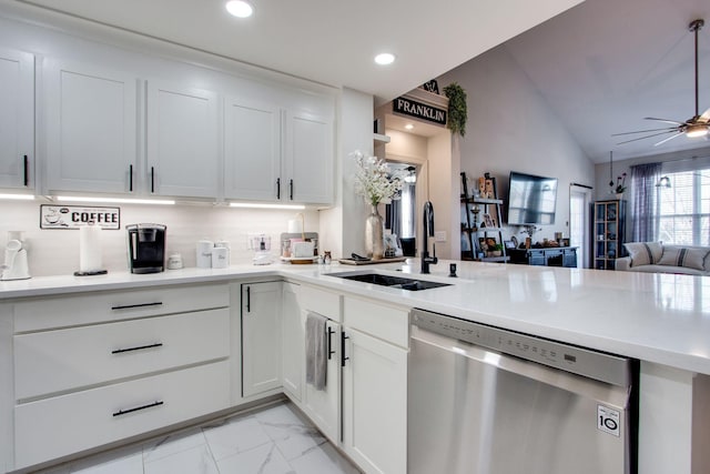 kitchen with a ceiling fan, open floor plan, a peninsula, stainless steel dishwasher, and a sink