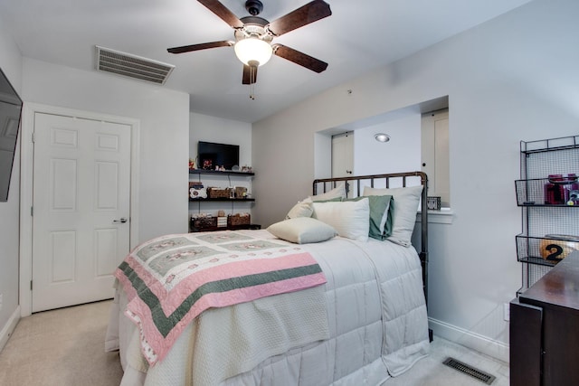 bedroom with baseboards, a ceiling fan, visible vents, and light colored carpet