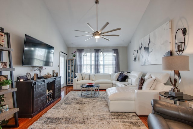 living room featuring lofted ceiling, wood finished floors, and a ceiling fan