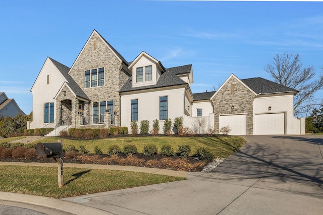 view of front of property featuring driveway, stone siding, and a front yard