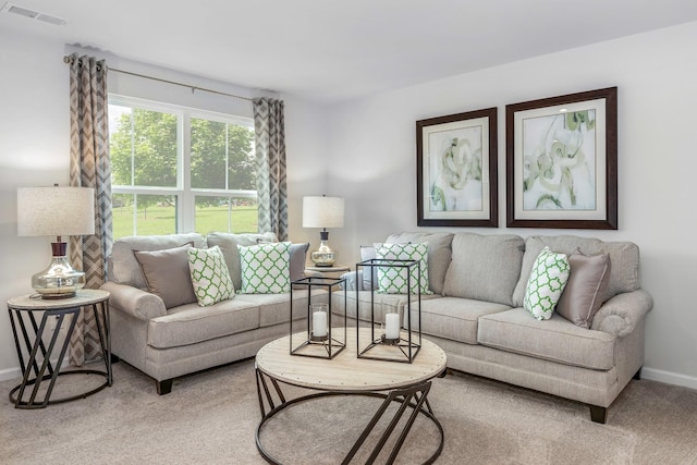 living room with baseboards, visible vents, and carpet flooring