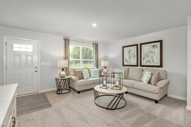 living room with visible vents, recessed lighting, light colored carpet, and baseboards