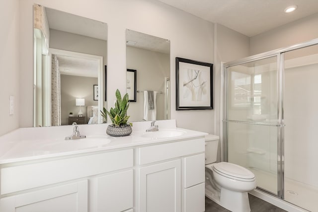 bathroom featuring a shower stall, connected bathroom, and a sink