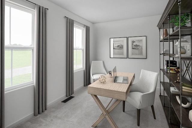 office area with visible vents, baseboards, a wealth of natural light, and light colored carpet