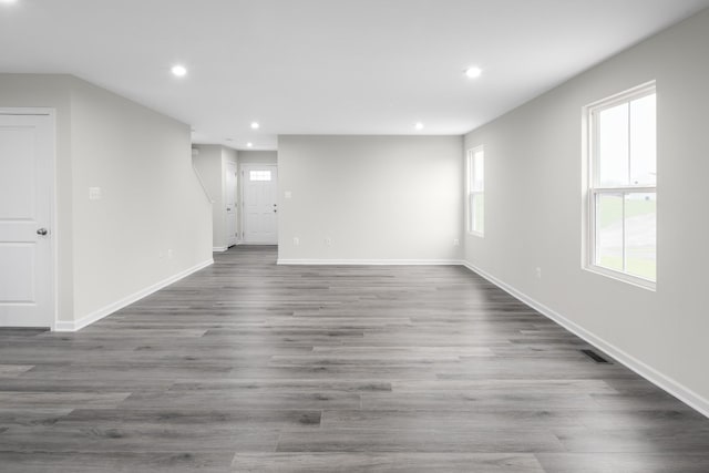 interior space featuring baseboards, wood finished floors, visible vents, and recessed lighting