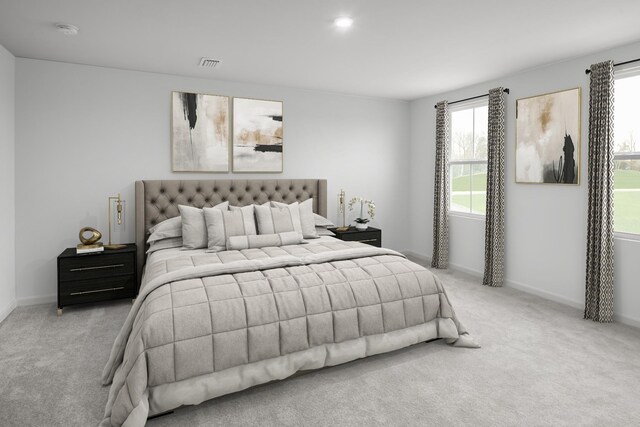 bedroom with multiple windows, visible vents, and light colored carpet