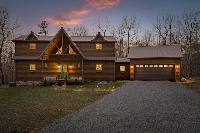 view of front of home featuring metal roof, a garage, a front yard, crawl space, and gravel driveway