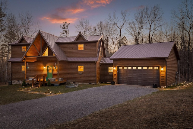 view of front of house featuring aphalt driveway, crawl space, log veneer siding, and metal roof