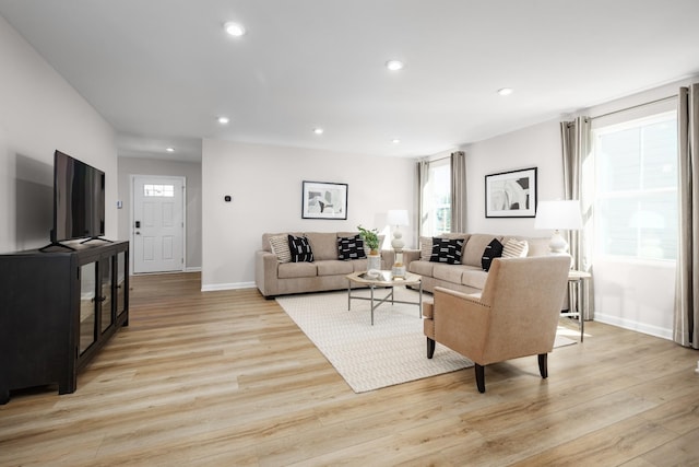 living room featuring light wood-style floors, baseboards, and recessed lighting