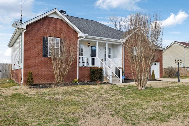 ranch-style house with brick siding, roof with shingles, a porch, an attached garage, and a front yard