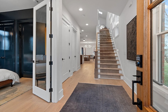 entrance foyer featuring recessed lighting, light wood-style flooring, and stairs