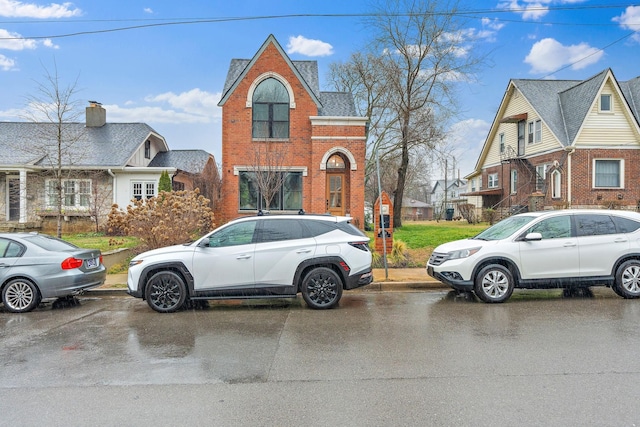 view of front of property with a residential view and brick siding