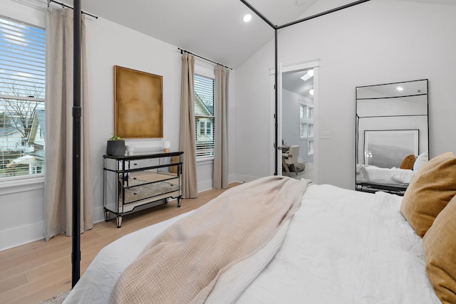 bedroom featuring light wood-style floors, recessed lighting, vaulted ceiling, and baseboards