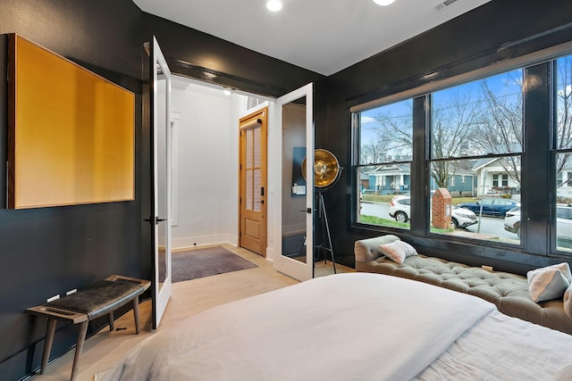 bedroom featuring french doors and baseboards