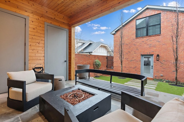 view of patio with an outdoor living space with a fire pit