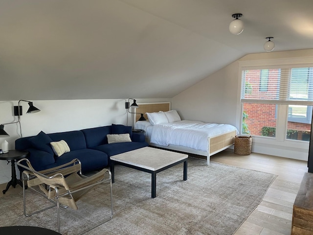 bedroom featuring vaulted ceiling and wood finished floors