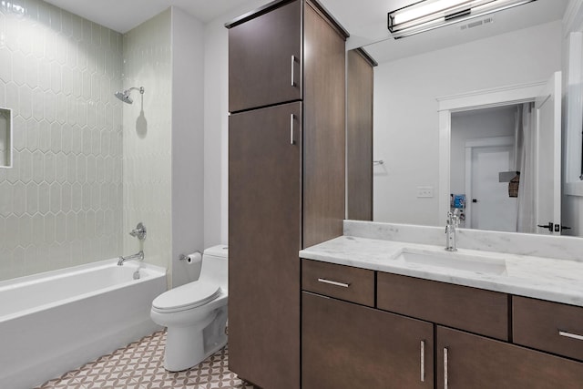 bathroom with toilet, visible vents, vanity, tile patterned floors, and washtub / shower combination