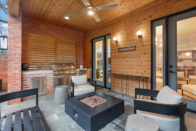 view of patio featuring area for grilling, an outdoor fire pit, grilling area, and a ceiling fan