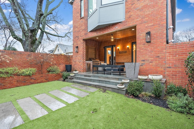 exterior space with a patio area, fence, and brick siding