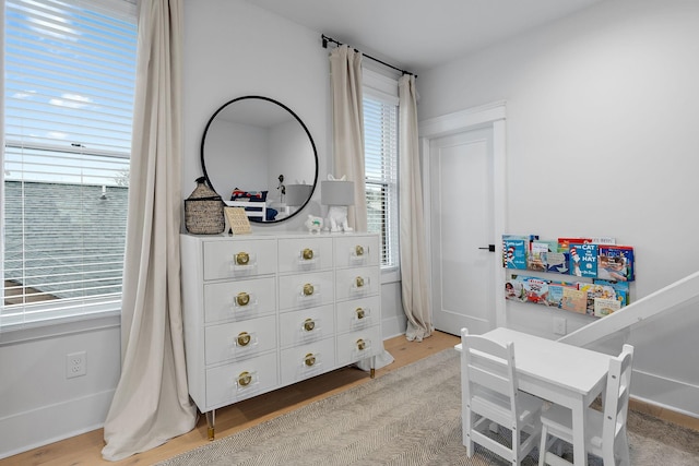 bedroom featuring multiple windows and wood finished floors