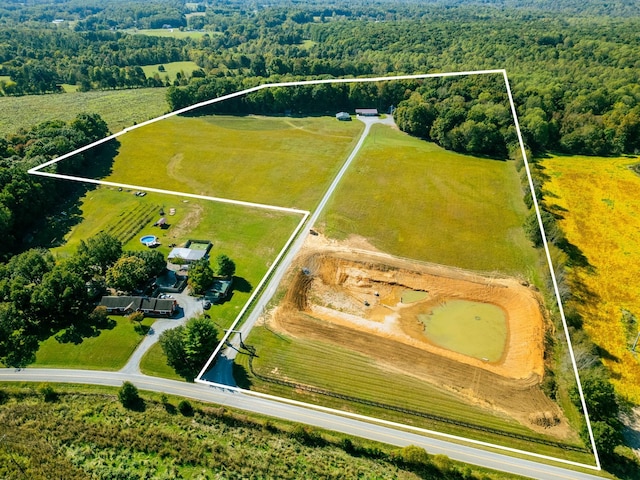 birds eye view of property featuring a rural view and a forest view