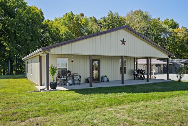 rear view of property with a yard and a patio