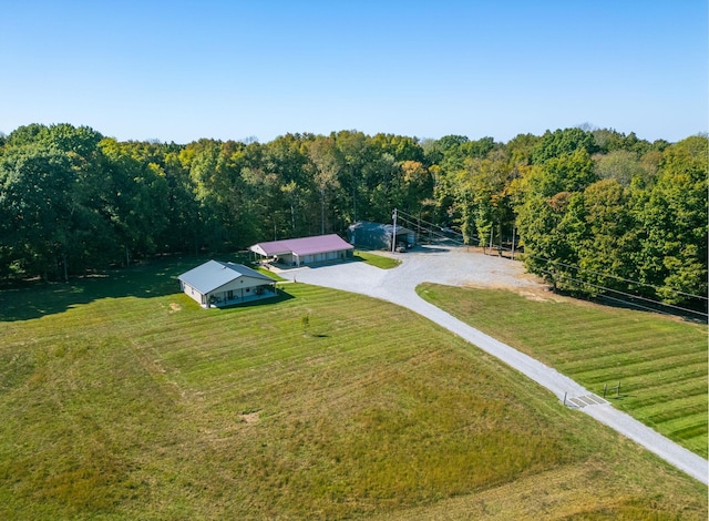 drone / aerial view with a view of trees and a rural view