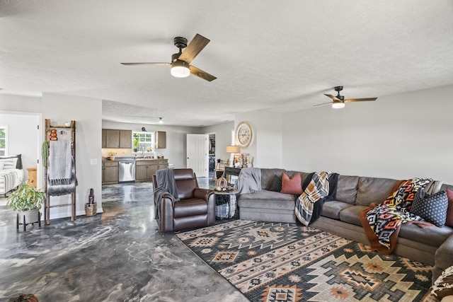 living room with a ceiling fan, concrete floors, and a textured ceiling