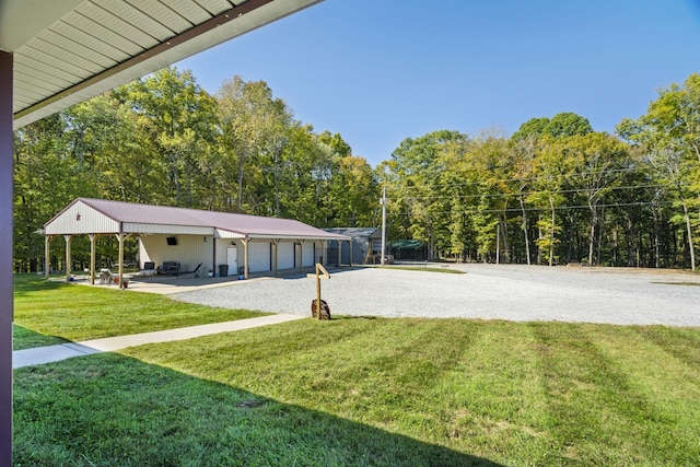 view of property's community featuring a lawn, driveway, and an attached garage