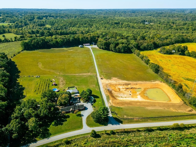 birds eye view of property with a forest view and a rural view