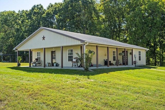 view of front of house with metal roof and a front lawn