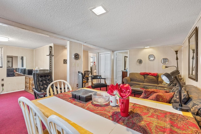 carpeted dining room featuring a textured ceiling