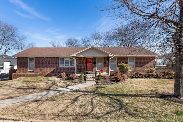 ranch-style home with brick siding, a front lawn, and a porch