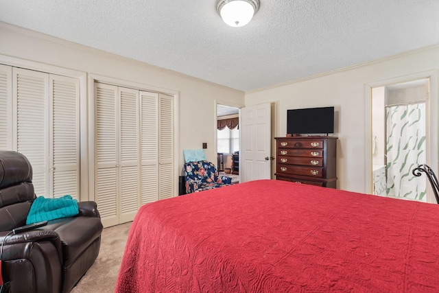 bedroom featuring crown molding, a textured ceiling, and light colored carpet