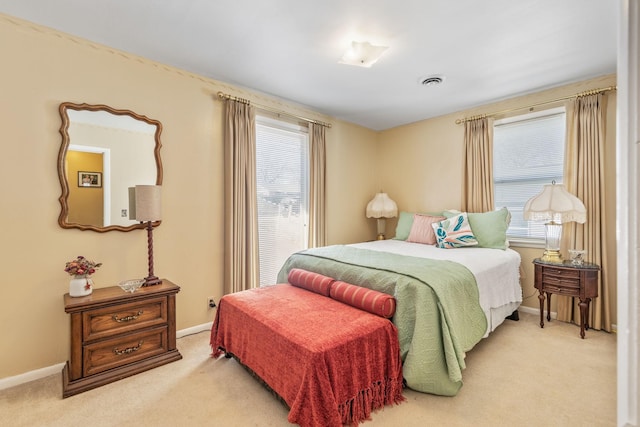 bedroom with carpet floors, multiple windows, and visible vents