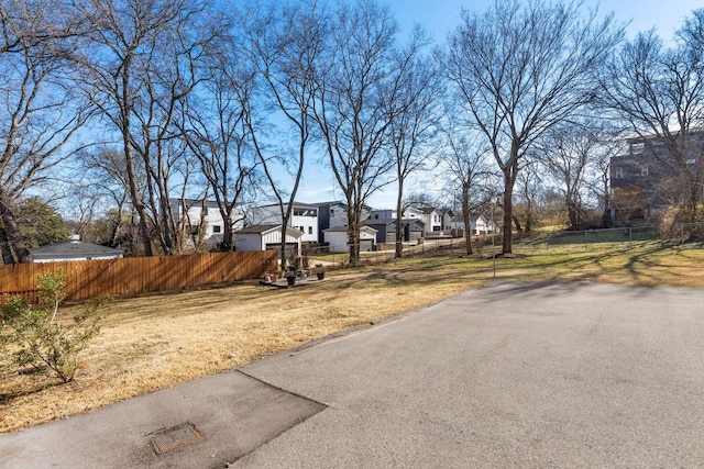 view of yard featuring a residential view and fence