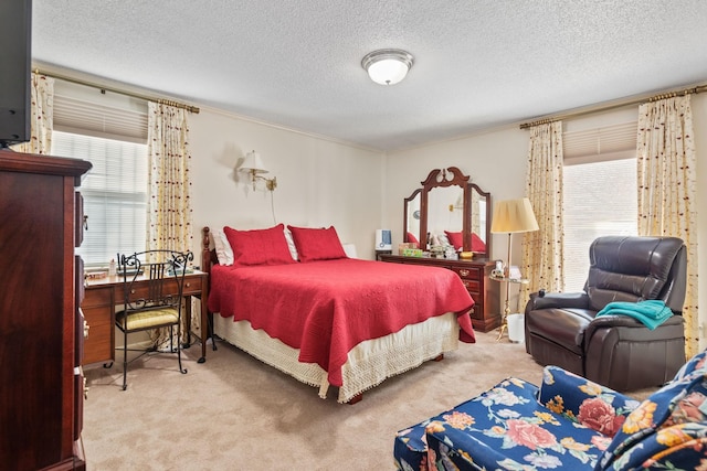 carpeted bedroom featuring multiple windows and a textured ceiling