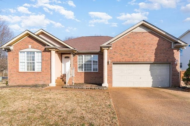 ranch-style house featuring a garage, a front lawn, brick siding, and driveway