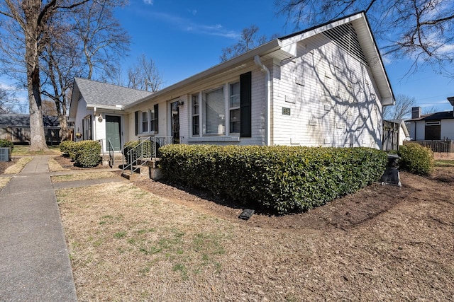 view of property exterior featuring brick siding and central AC unit