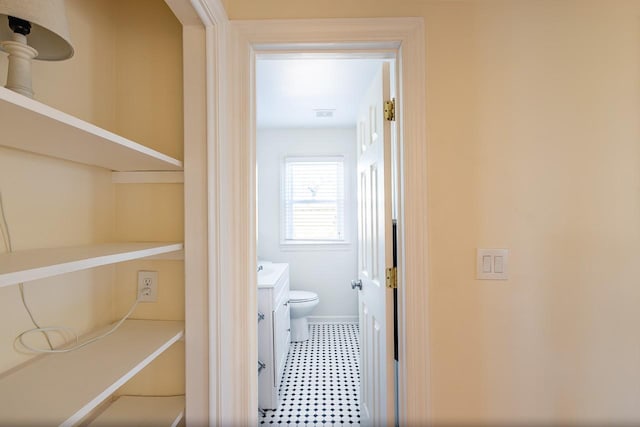 bathroom featuring vanity, toilet, and tile patterned floors