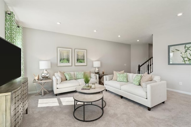 living area with carpet floors, baseboards, stairway, and recessed lighting