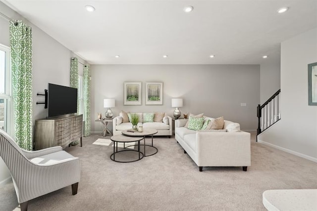 living area featuring carpet floors, recessed lighting, baseboards, and stairs