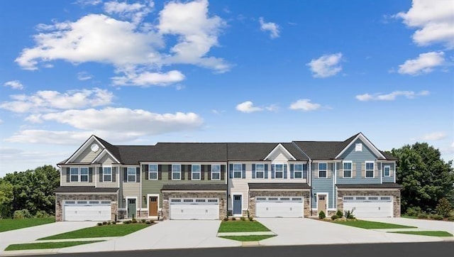 multi unit property featuring stone siding and an attached garage