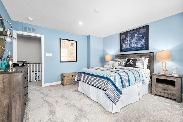 carpeted bedroom with visible vents and baseboards