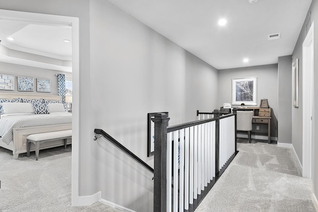 hallway with carpet floors, recessed lighting, visible vents, an upstairs landing, and baseboards