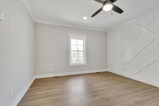 unfurnished room featuring crown molding, light wood-style flooring, and baseboards