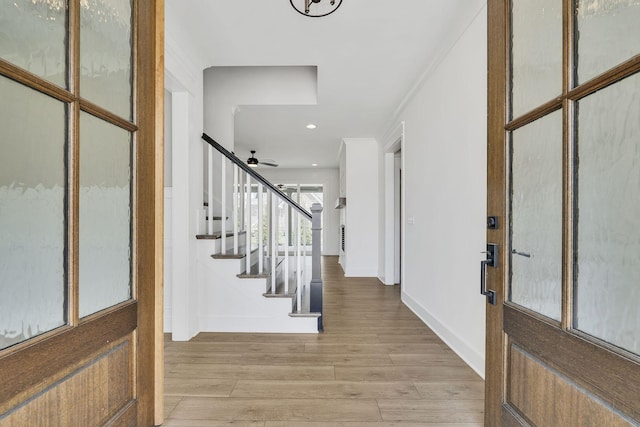 foyer entrance featuring recessed lighting, a ceiling fan, baseboards, stairs, and light wood-type flooring