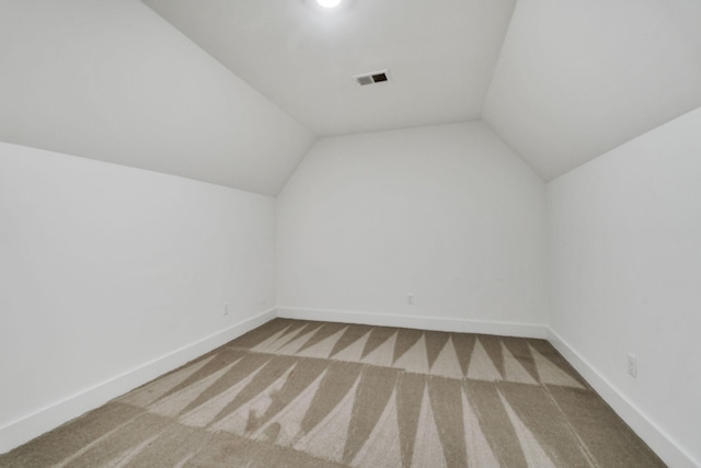 bonus room featuring vaulted ceiling, carpet, visible vents, and baseboards